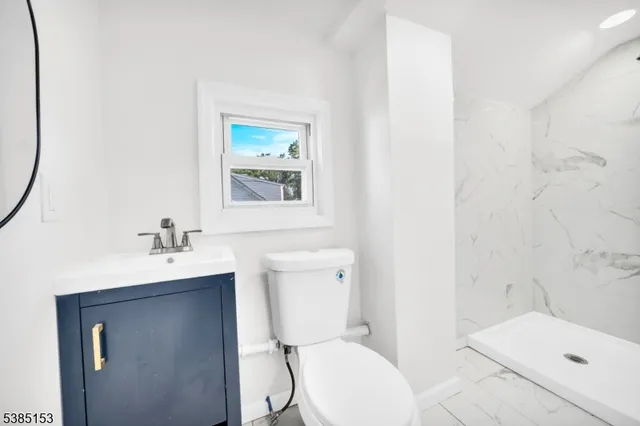 a white toilet sitting next to a bathroom sink