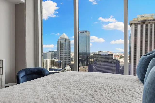 a bedroom with a large bed and a window