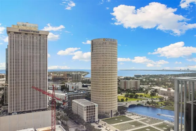 a view of a bedroom with a bed and wooden floor