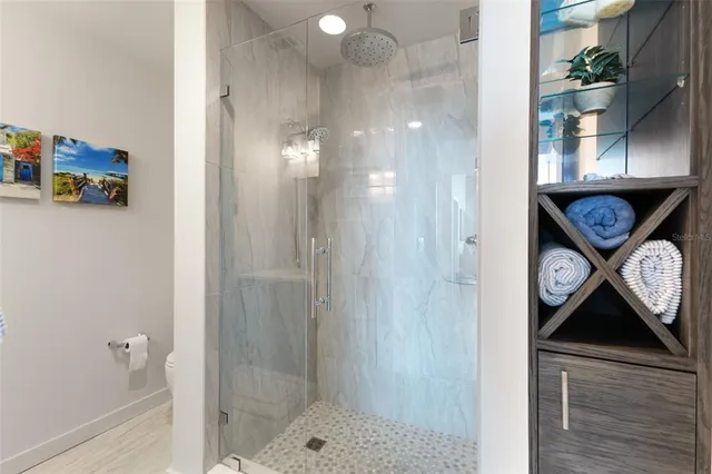 a view of a livingroom with furniture and floor to ceiling window