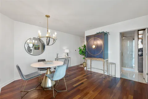 a living room with furniture tv and city view