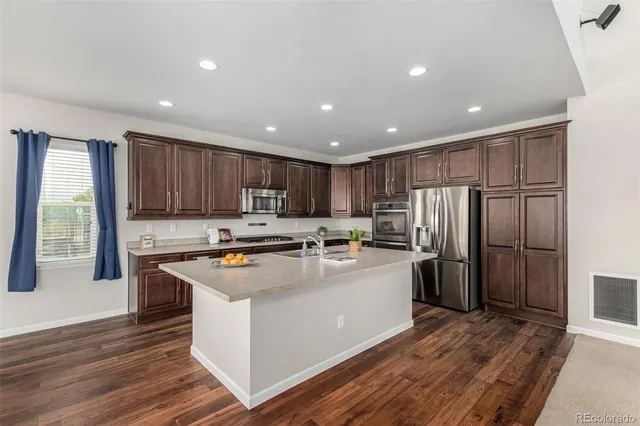 a kitchen with refrigerator and cabinets