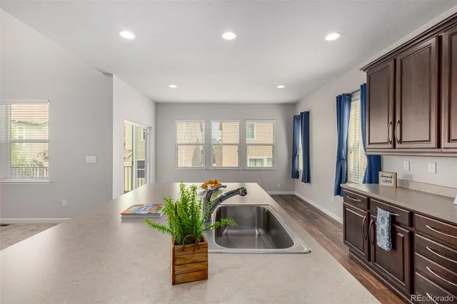 a hallway with a faucet a chandelier and wooden floor