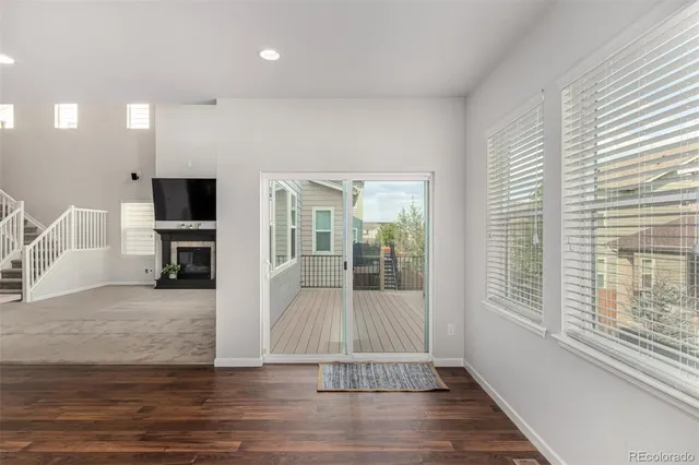 a kitchen with stainless steel appliances granite countertop a refrigerator a sink dishwasher a stove and white countertops with wooden floor