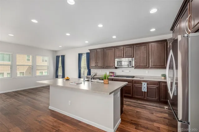 an empty room with windows and cabinet