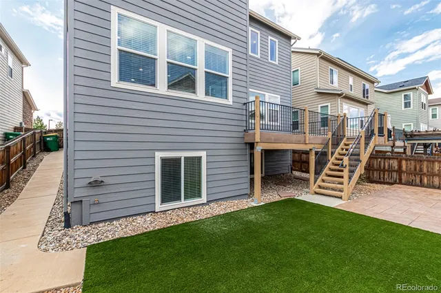 an aerial view of a house with a swimming pool and outdoor seating
