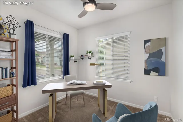 a view of a workspace with furniture and a window