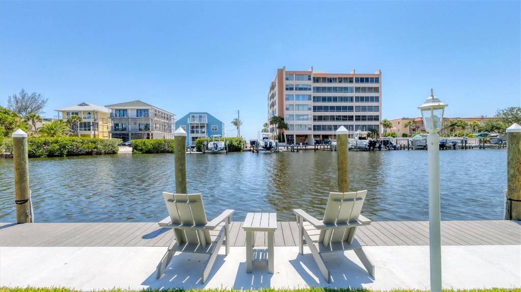 9200 Midnight Pass Road, Unit 24 Sarasota, FL 34242 - Photo 34 of 43 a view of a lake with tall buildings