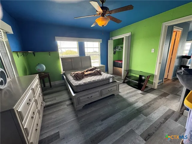 a living room with furniture flat screen tv and a large window