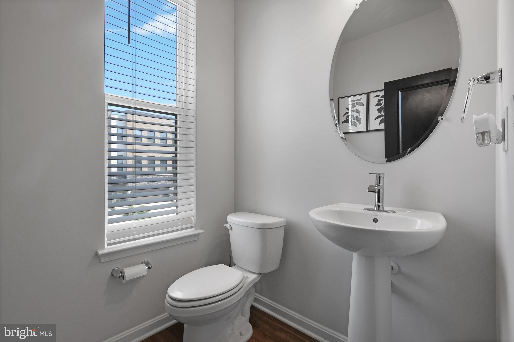854 Amity Street Frederick, MD 21701 - Photo 15 of 62 a bathroom with a toilet a sink and a mirror