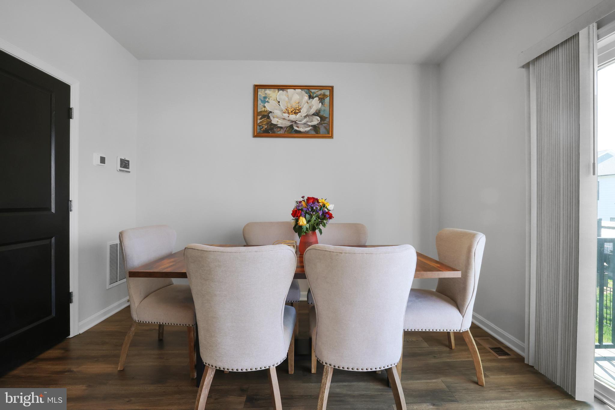 854 Amity Street Frederick, MD 21701 - Photo 17 of 62 a view of a dining room with furniture and wooden floor