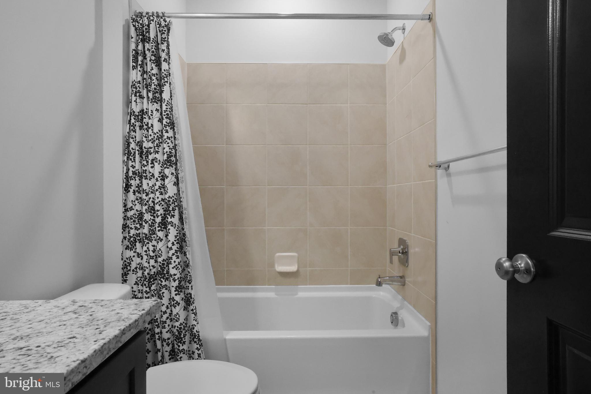 854 Amity Street Frederick, MD 21701 - Photo 31 of 62 a bathroom with a bathtub a sink and a shower
