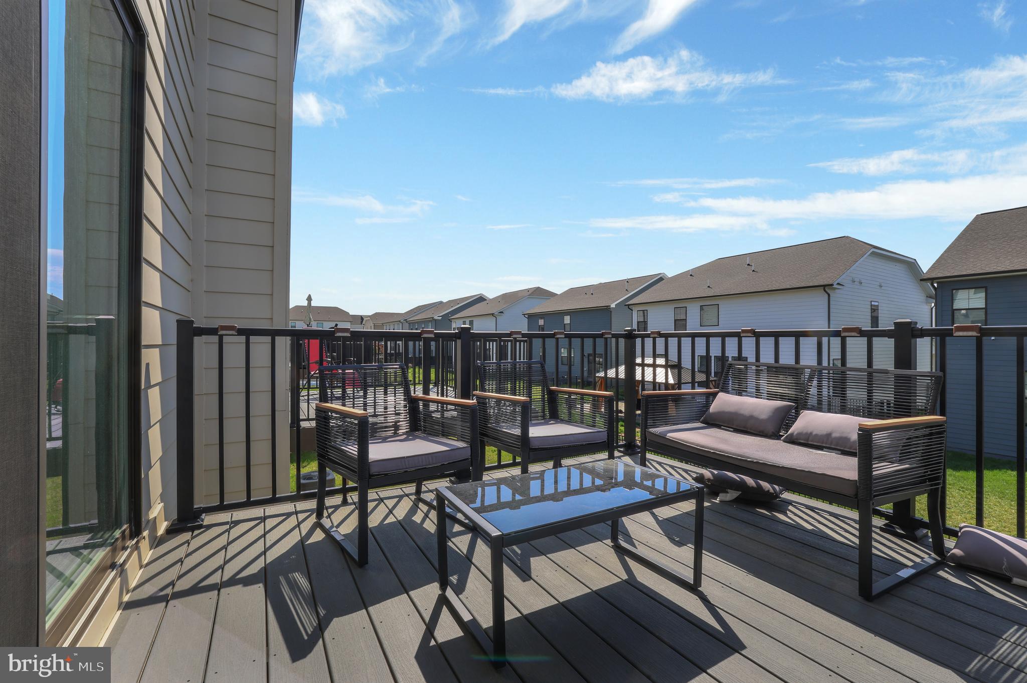 854 Amity Street Frederick, MD 21701 - Photo 34 of 62 a roof deck with a table and chairs with wooden floor