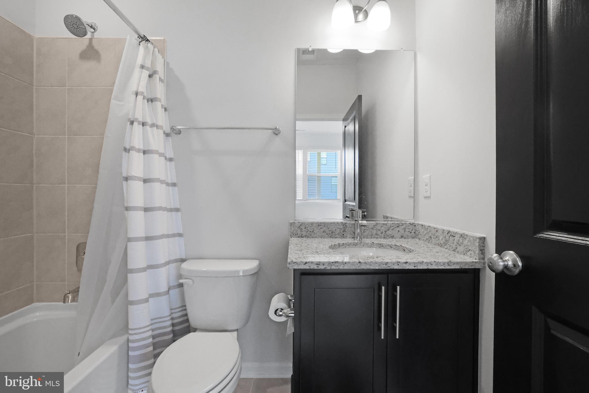854 Amity Street Frederick, MD 21701 - Photo 42 of 62 a bathroom with a granite countertop sink toilet and shower