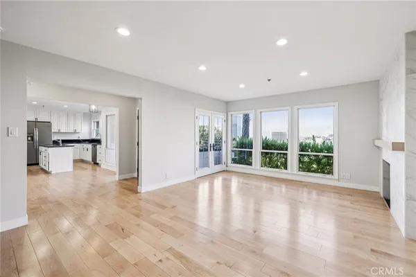 a kitchen with granite countertop a sink a counter space appliances and cabinets