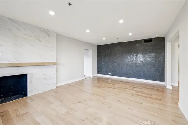 a kitchen with stainless steel appliances granite countertop white cabinets and a stove top oven