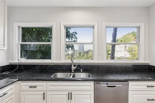 a view of empty room with wooden floor and window