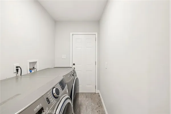 a white house with a yard and potted plants