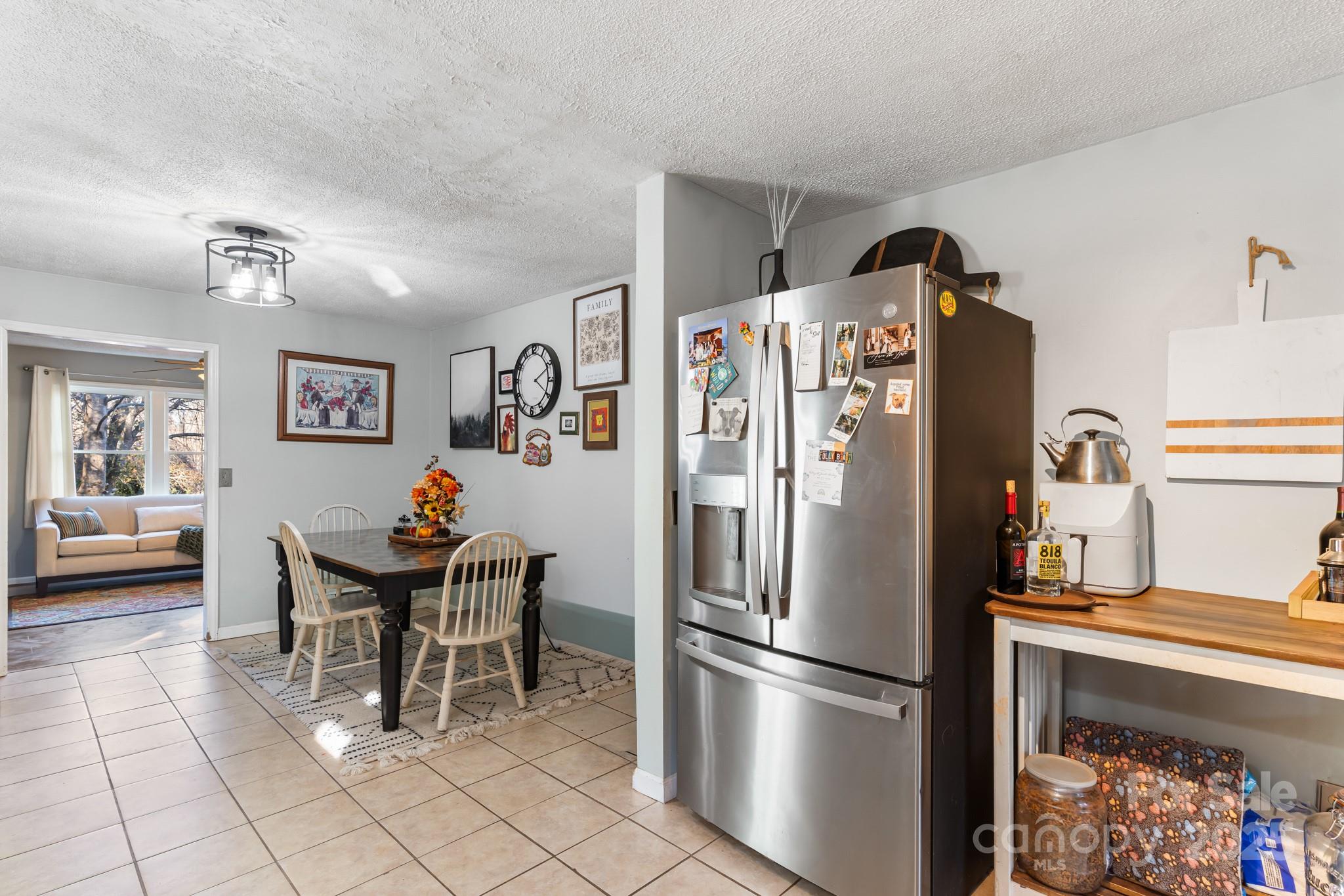 14 Sluder Branch Road Candler, NC 28715 - Photo 11 of 21 a kitchen with stainless steel appliances granite countertop a refrigerator and a stove top oven