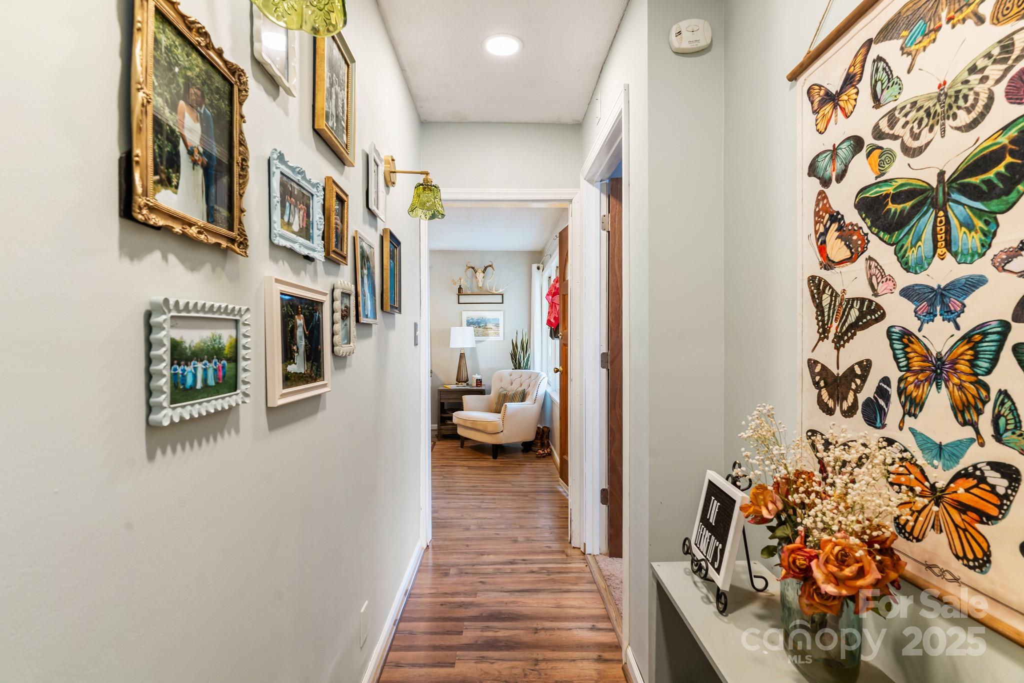 14 Sluder Branch Road Candler, NC 28715 - Photo 12 of 21 a view of a hallway with wooden floor and a potted plant