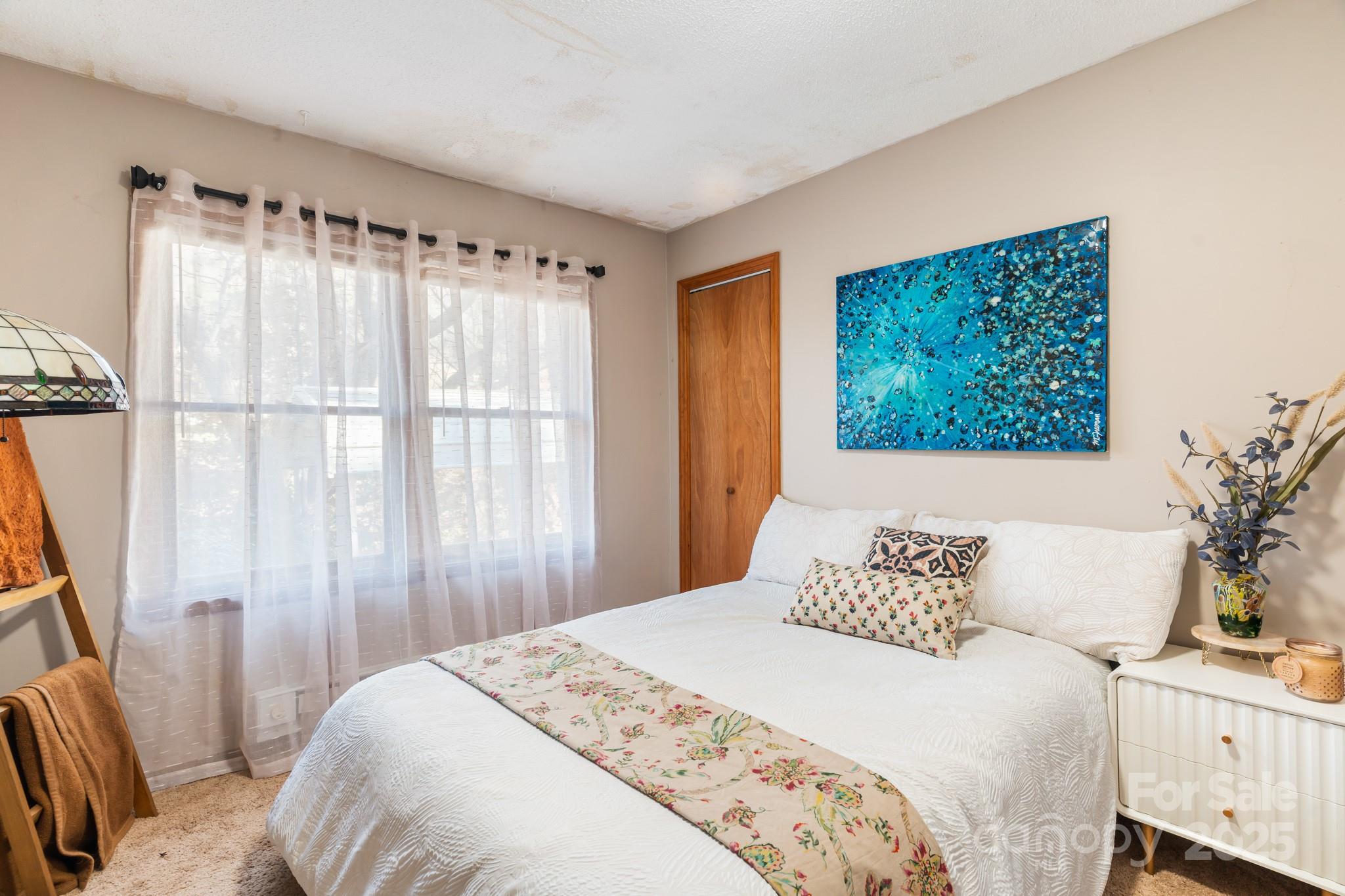 14 Sluder Branch Road Candler, NC 28715 - Photo 14 of 21 a bedroom with a bed and a window