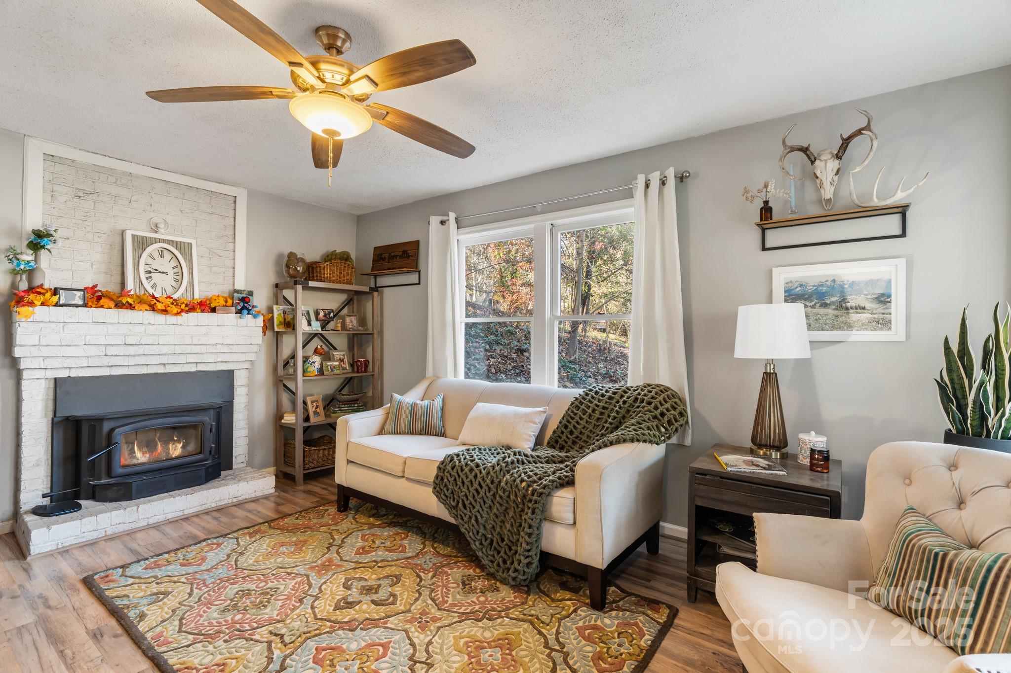 14 Sluder Branch Road Candler, NC 28715 - Photo 4 of 21 a living room with furniture and a fireplace