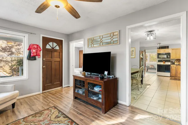 a open kitchen with stainless steel appliances granite countertop a stove top oven a sink dishwasher and cabinets with wooden floor