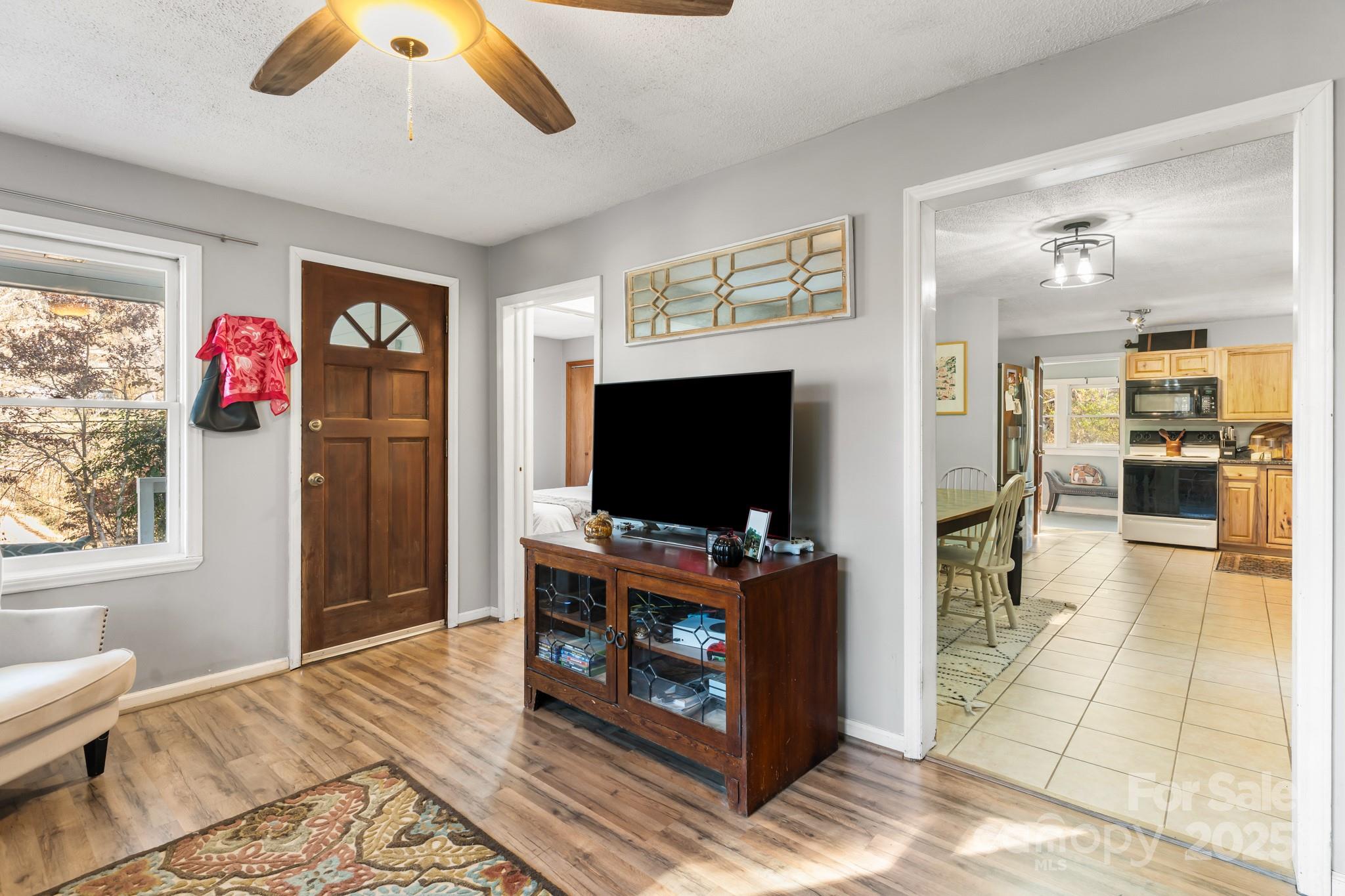 14 Sluder Branch Road Candler, NC 28715 - Photo 7 of 21 a living room with furniture and a flat screen tv