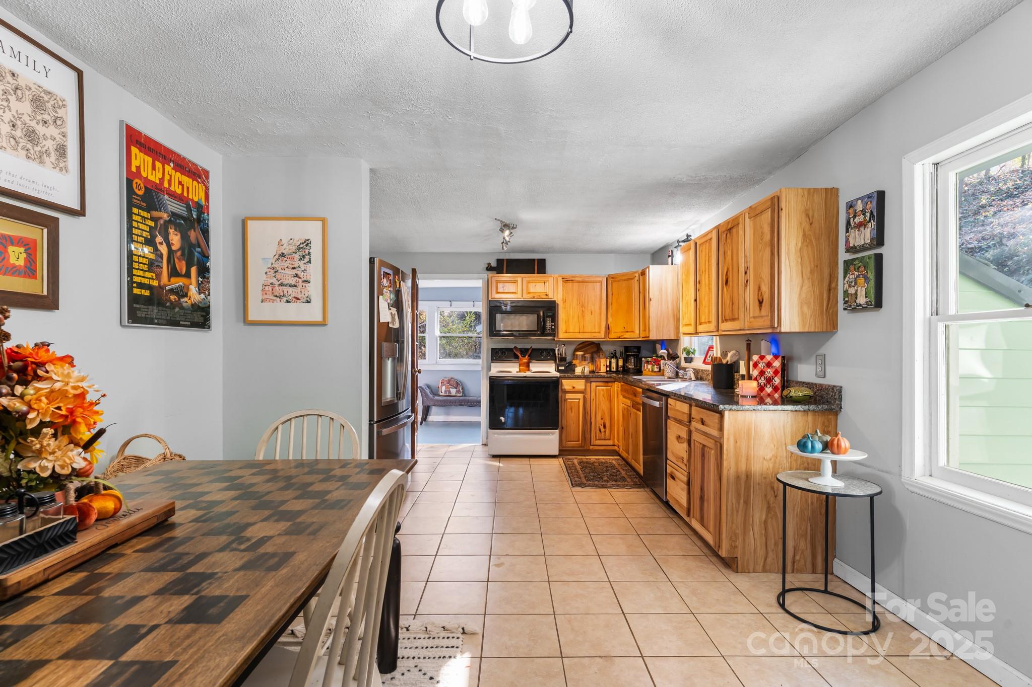 14 Sluder Branch Road Candler, NC 28715 - Photo 8 of 21 a open kitchen with stainless steel appliances granite countertop a stove top oven a sink dishwasher and cabinets with wooden floor
