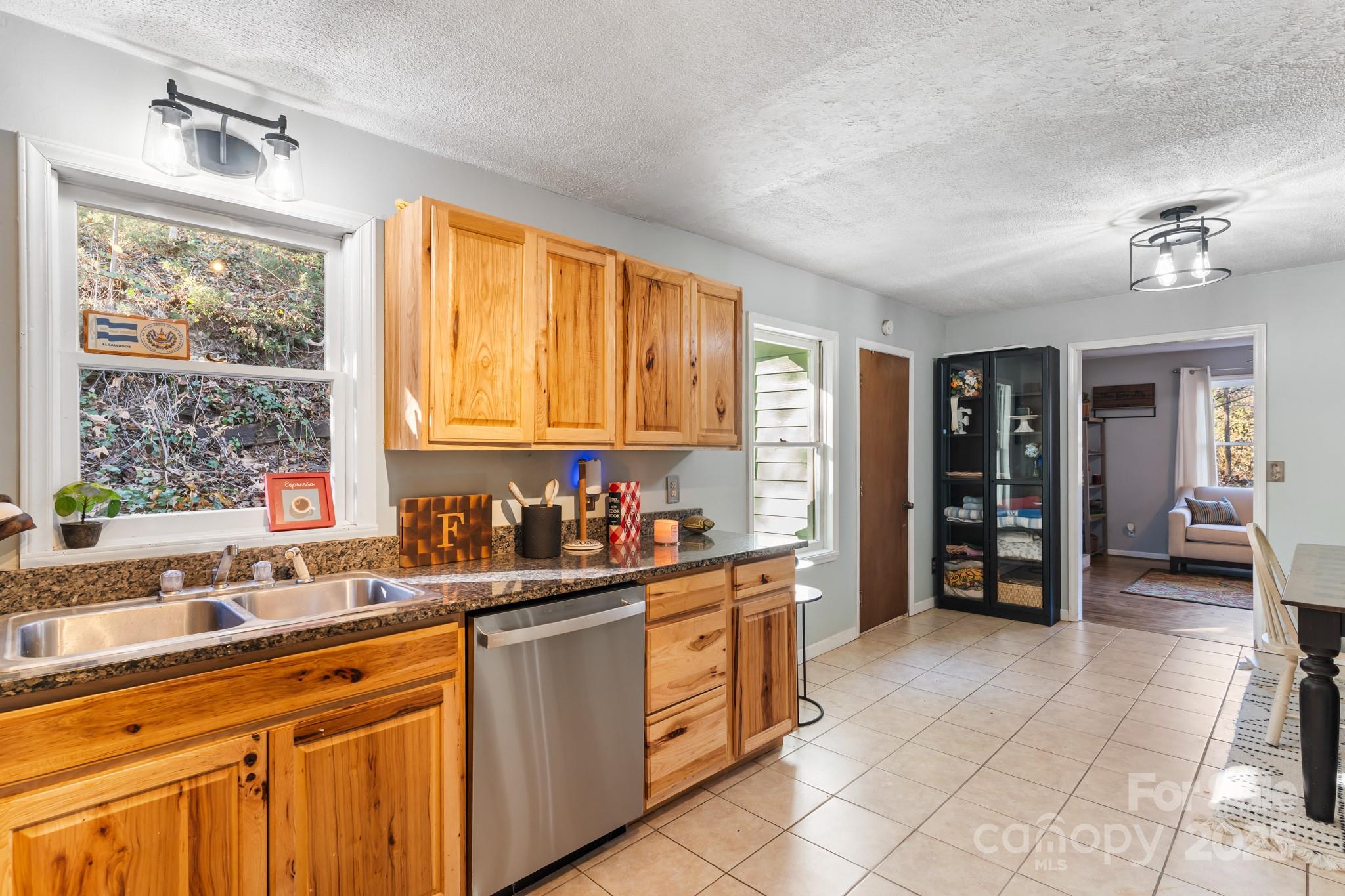 14 Sluder Branch Road Candler, NC 28715 - Photo 10 of 21 a kitchen with stainless steel appliances a sink stove and cabinets