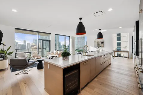 a kitchen with stainless steel appliances a sink a stove and wooden floor