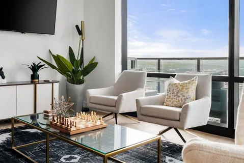 a living room with furniture and a potted plant