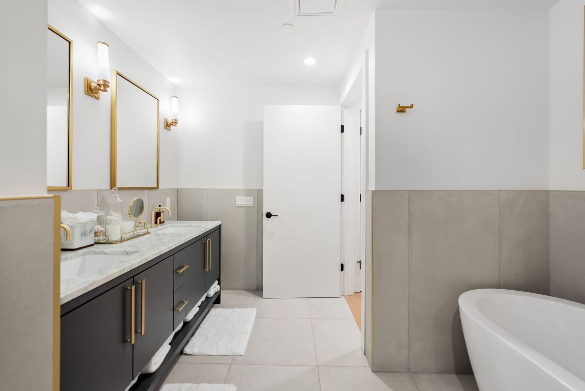70 Rainey Street, Unit 2606 Austin, TX 78701 - Photo 21 of 37 a bathroom with a granite countertop sink and a mirror