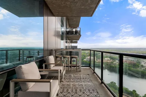a living room with furniture a potted plant and a window