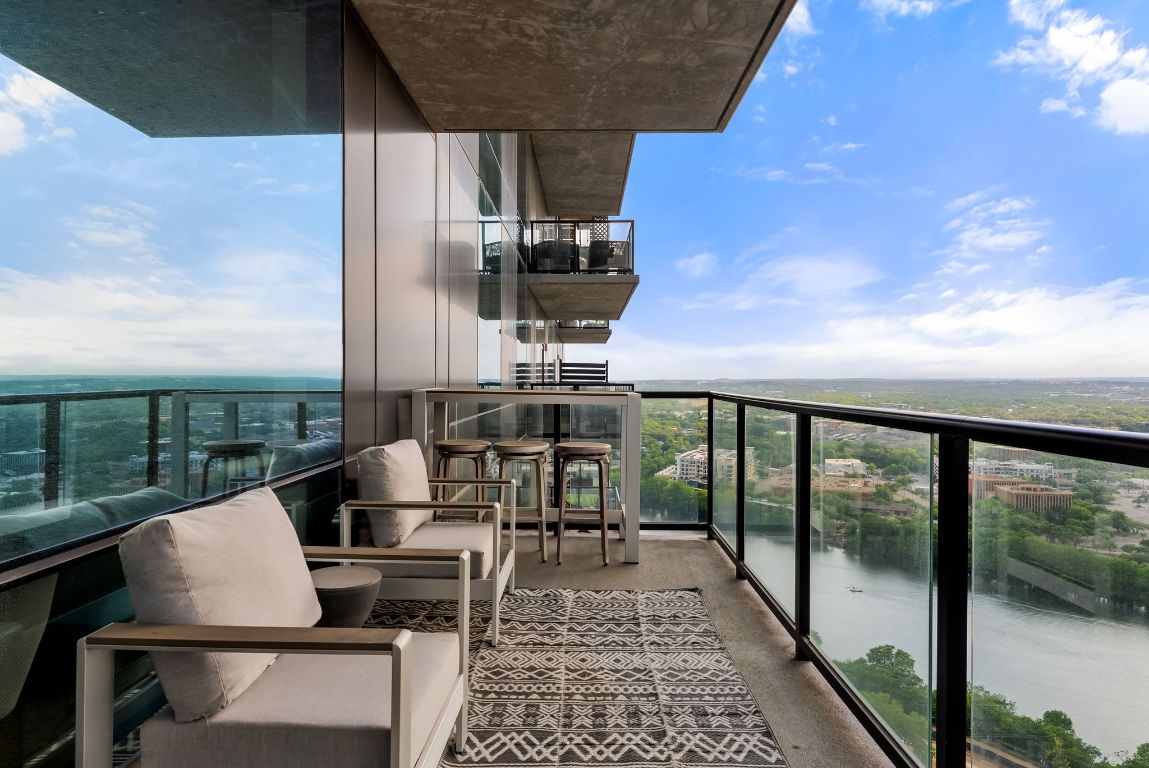 70 Rainey Street, Unit 2606 Austin, TX 78701 - Photo 24 of 37 a dining room with furniture and a floor to ceiling window