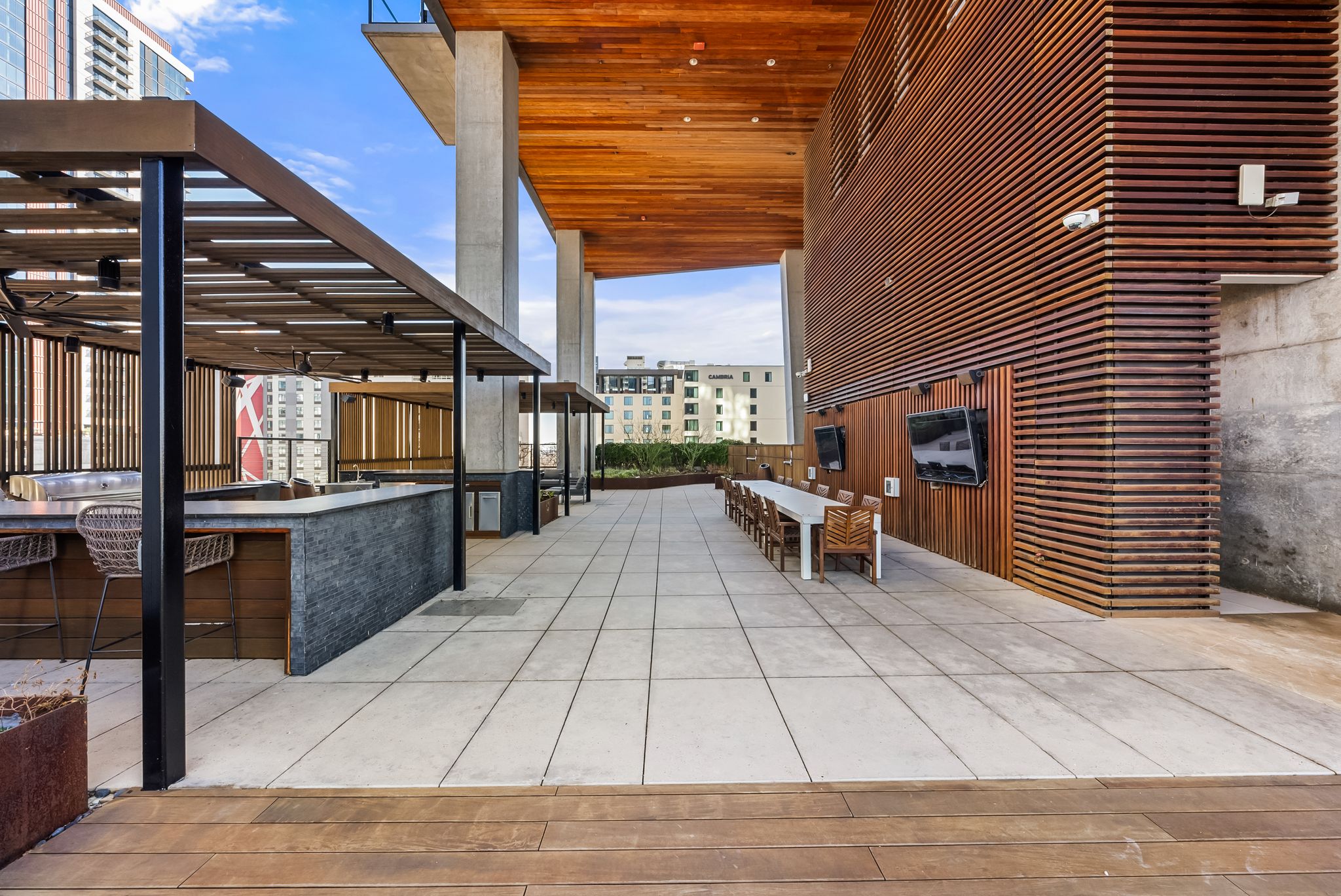 70 Rainey Street, Unit 2606 Austin, TX 78701 - Photo 30 of 37 a view of a patio with dining table and chairs with wooden floor and fence