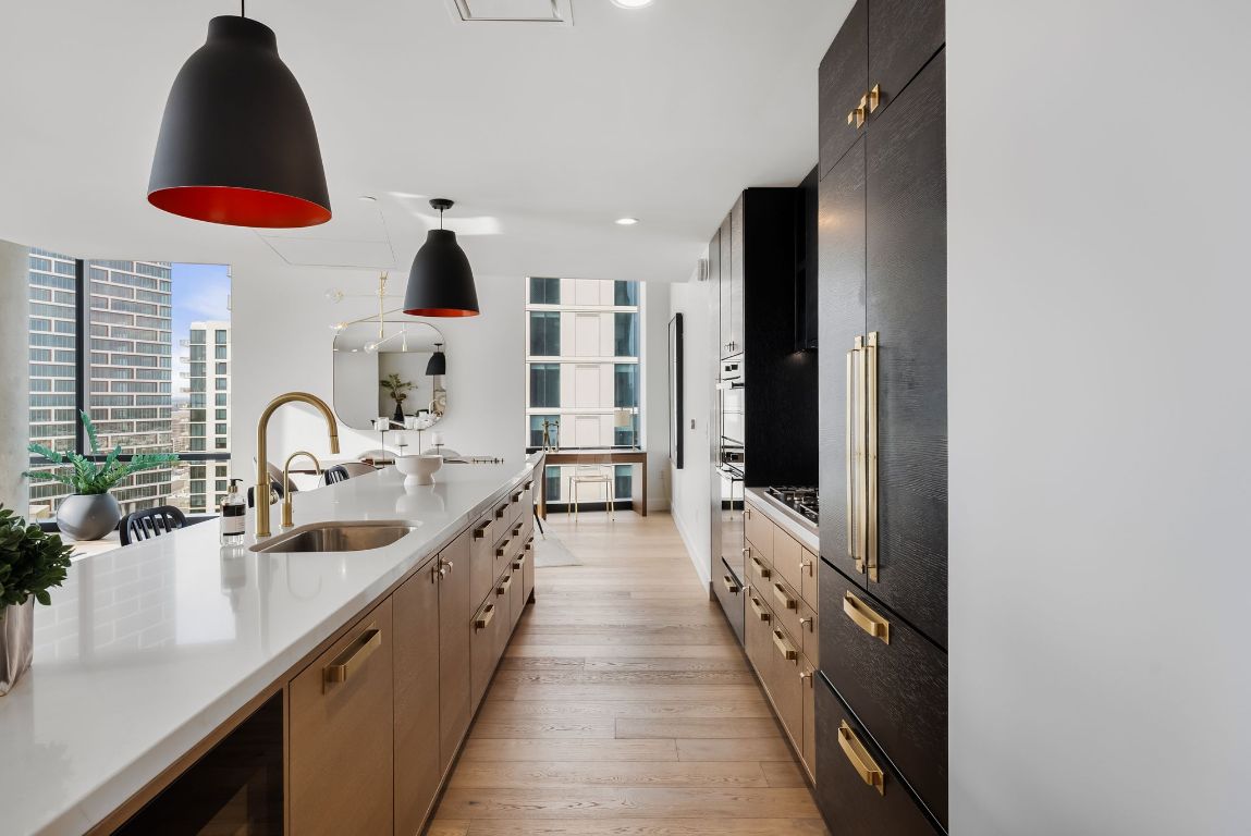 70 Rainey Street, Unit 2606 Austin, TX 78701 - Photo 9 of 37 a large kitchen with stainless steel appliances a sink and a large window