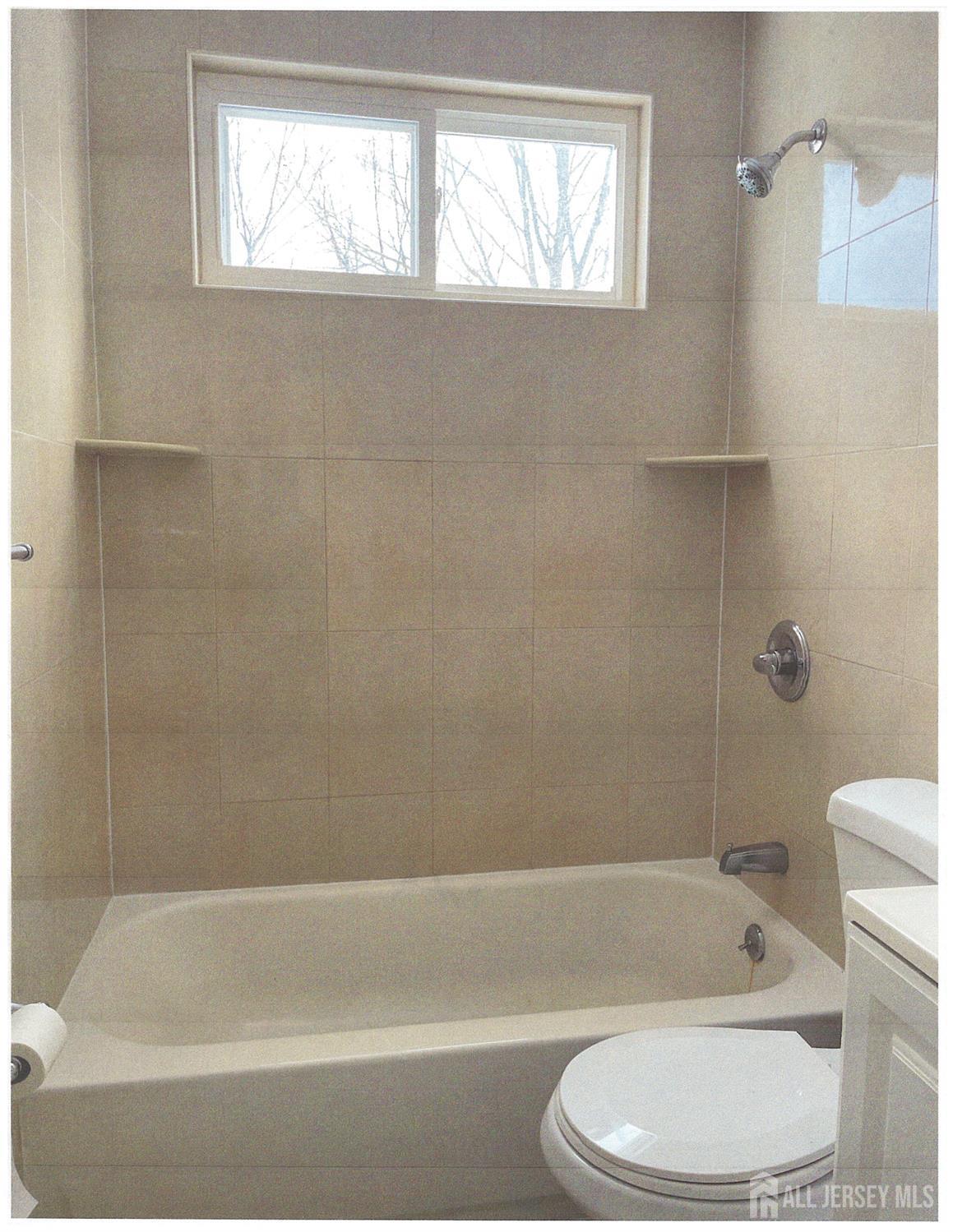 25 Hull Drive Edison, NJ 08817 - Photo 13 of 16 a bathroom with a toilet bathtub and shower