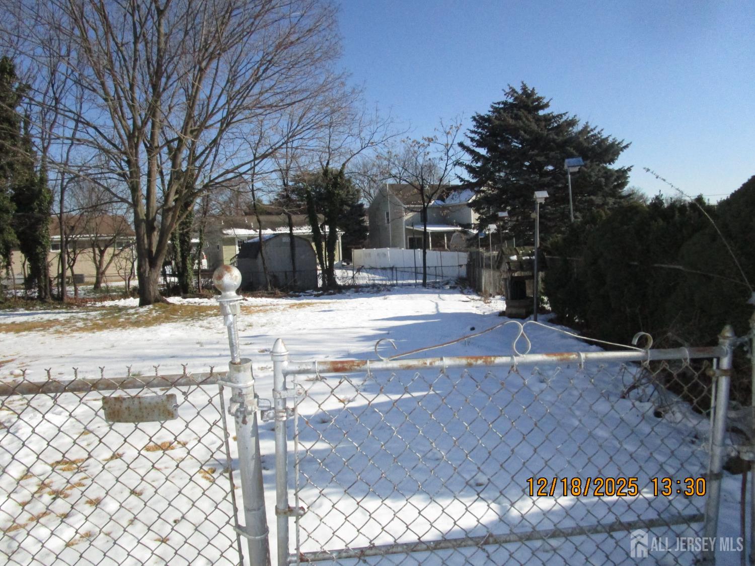 25 Hull Drive Edison, NJ 08817 - Photo 2 of 16 a view of a yard with snow on the road