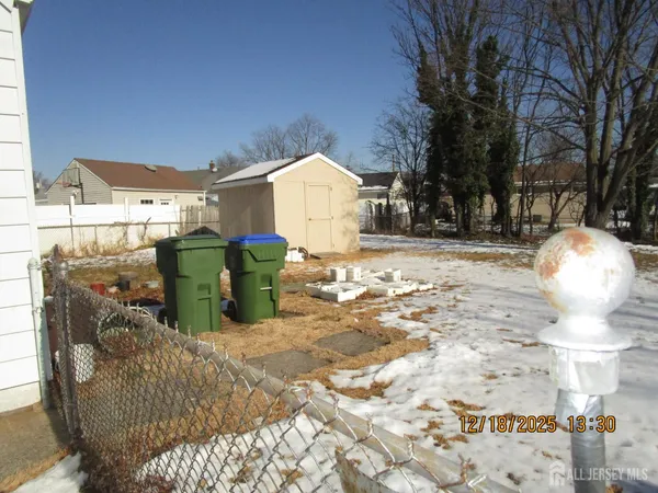 a view of a outdoor space with plants and barbeque oven