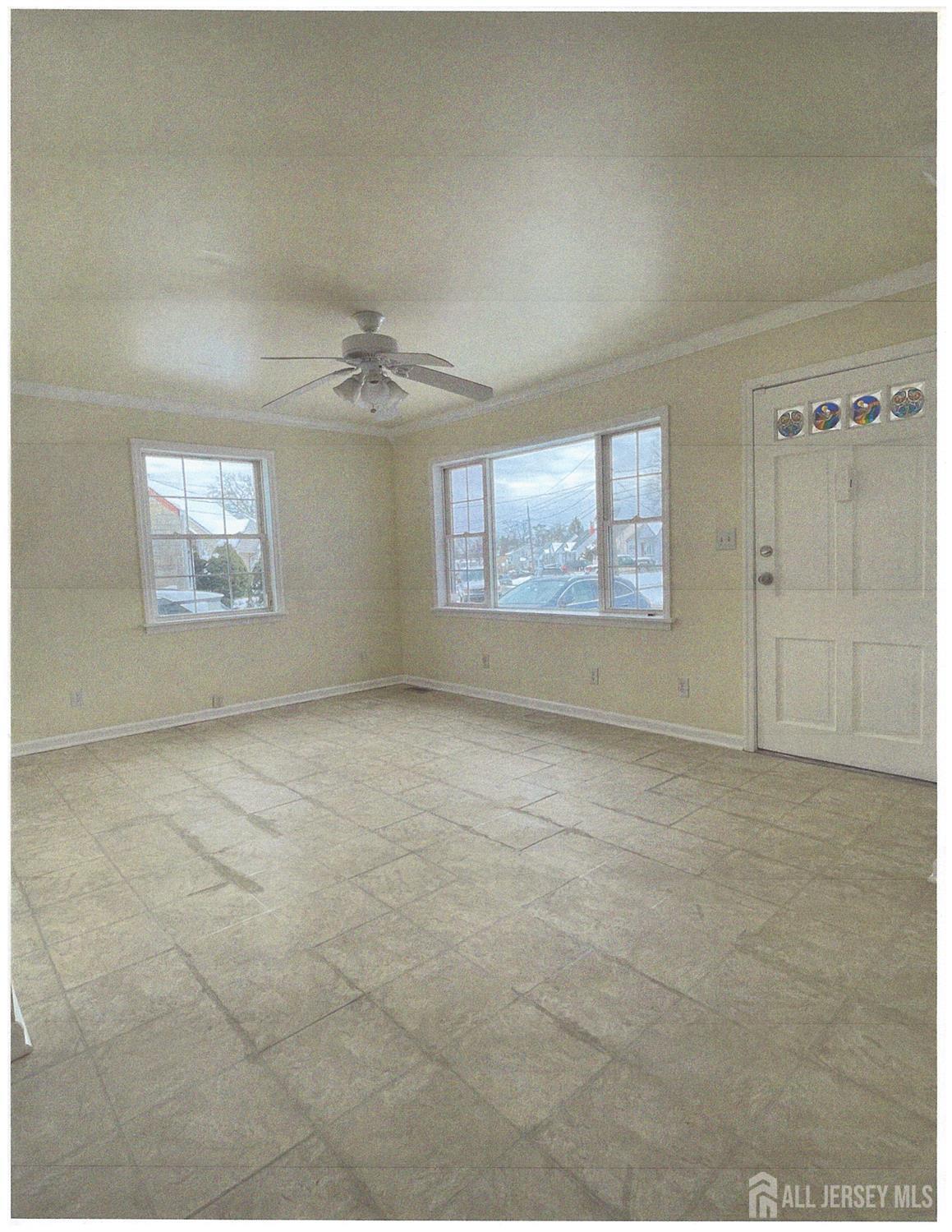 25 Hull Drive Edison, NJ 08817 - Photo 4 of 16 an empty room with windows and ceiling fan
