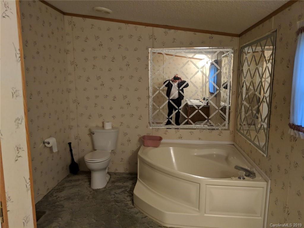1090 State Rd S-46-1102 York, SC 29745 - Photo 7 of 10 a bathroom with a bathtub and a shower
