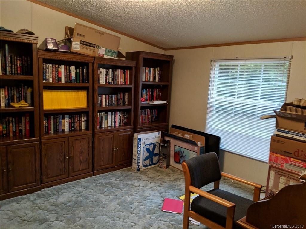 1090 State Rd S-46-1102 York, SC 29745 - Photo 8 of 10 a view of a workspace with furniture and a book shelf