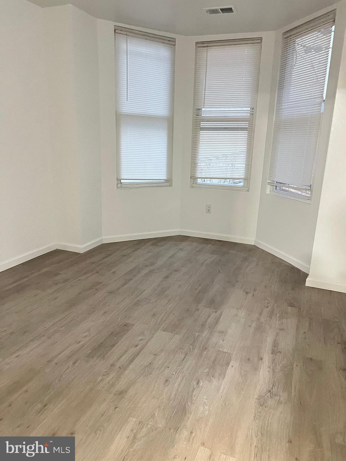 4422 Locust Street, Unit 1 2 Philadelphia, PA 19104 - Photo 22 of 30 an empty room with wooden floor and windows