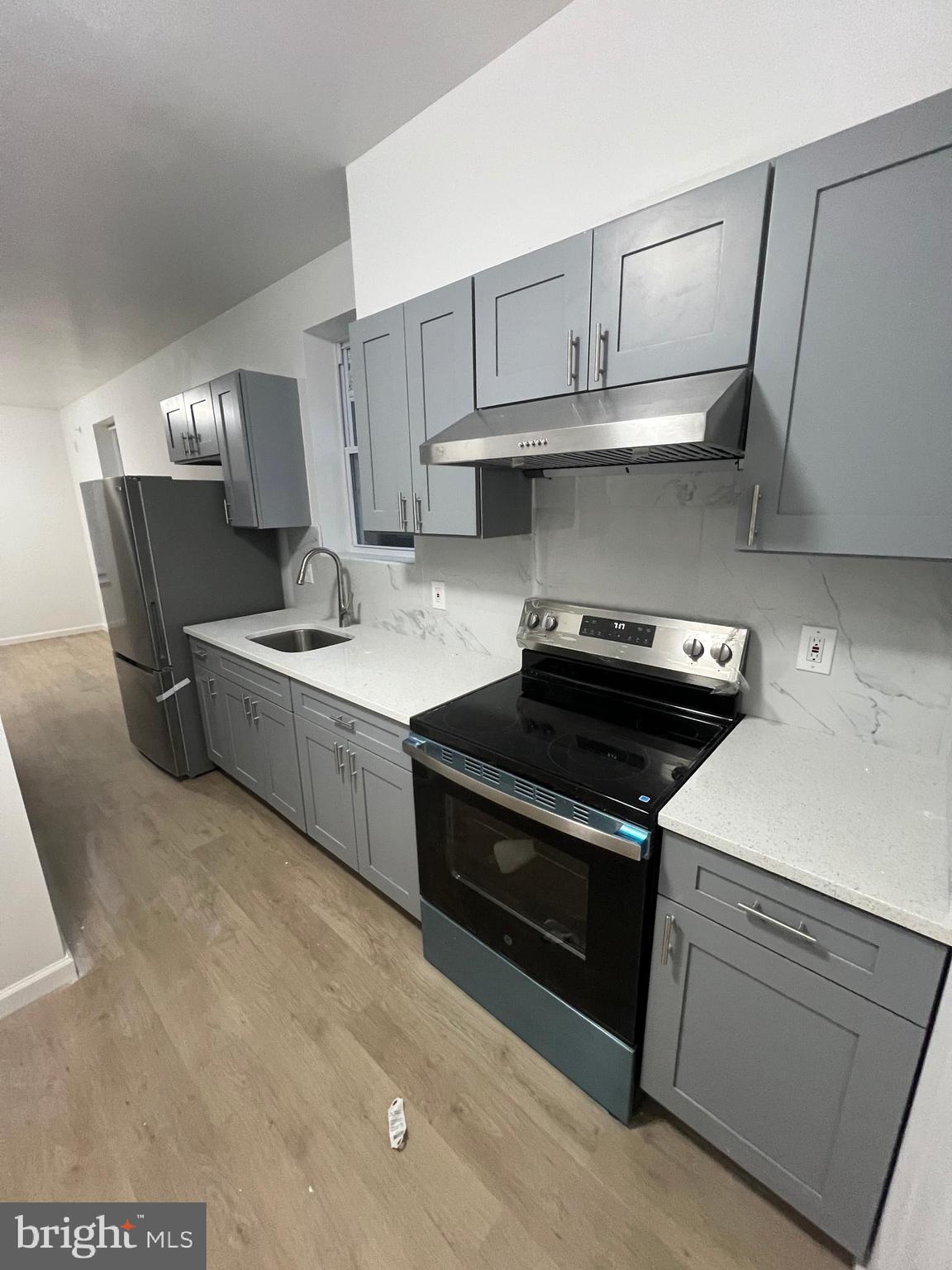 4422 Locust Street, Unit 1 2 Philadelphia, PA 19104 - Photo 25 of 30 a kitchen with a stove and a refrigerator