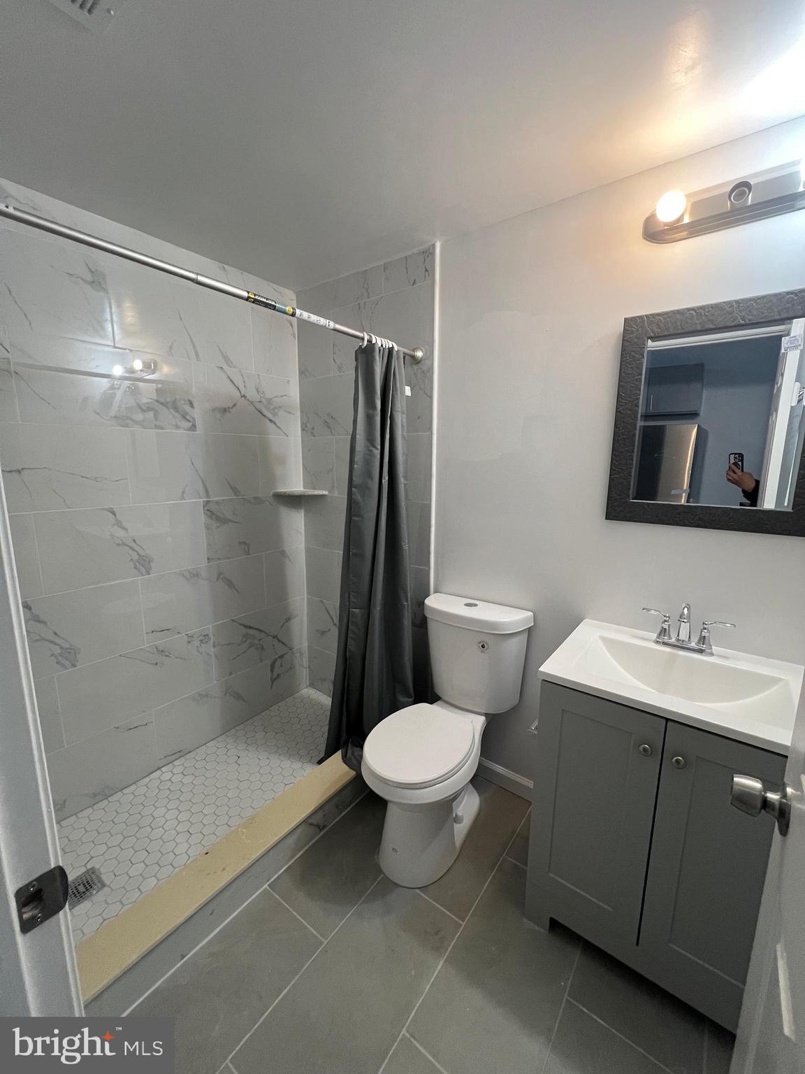 4422 Locust Street, Unit 1 2 Philadelphia, PA 19104 - Photo 26 of 30 a bathroom with a toilet sink and a shower