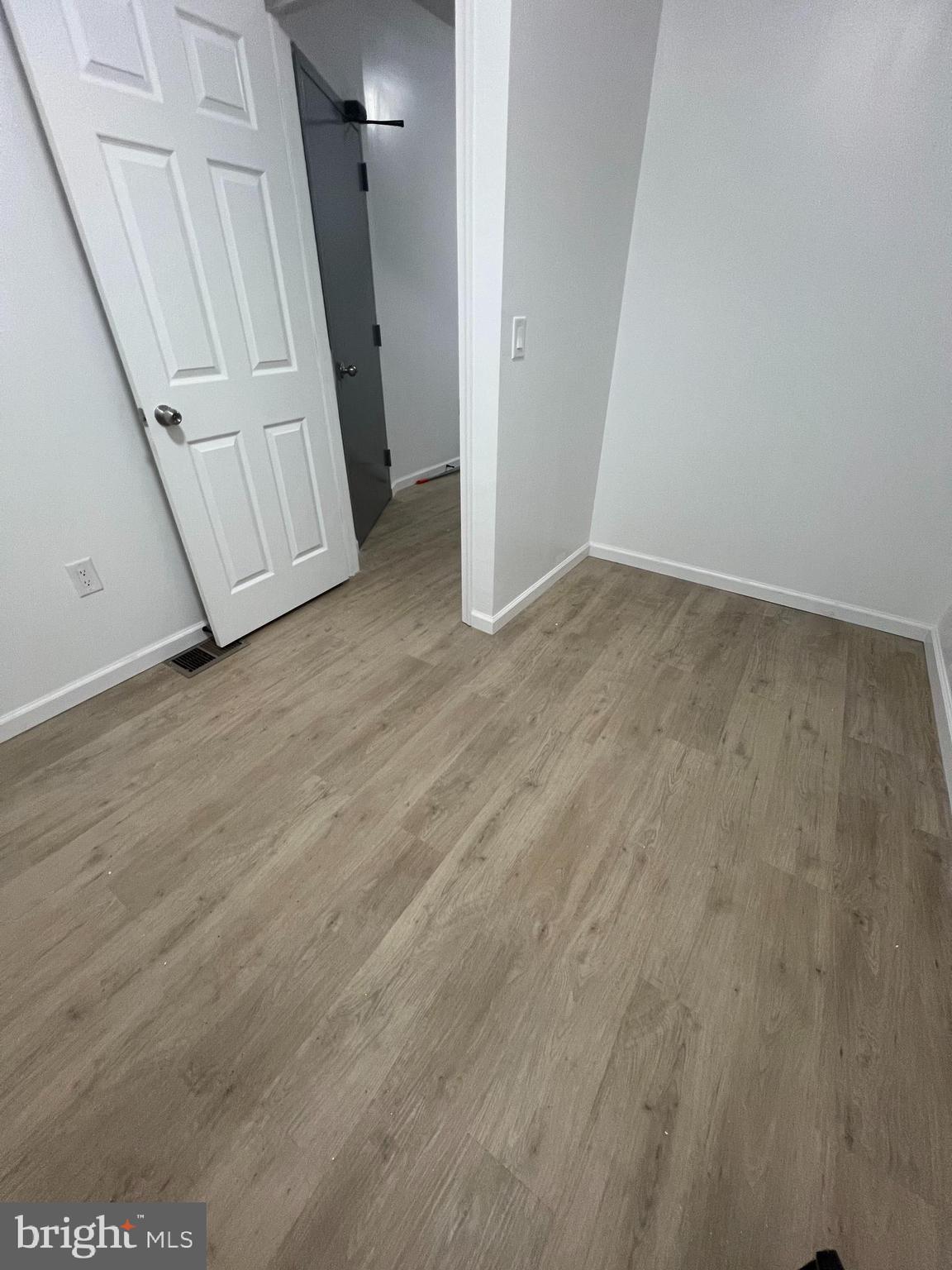 4422 Locust Street, Unit 1 2 Philadelphia, PA 19104 - Photo 4 of 30 an empty room with wooden floor and stairs