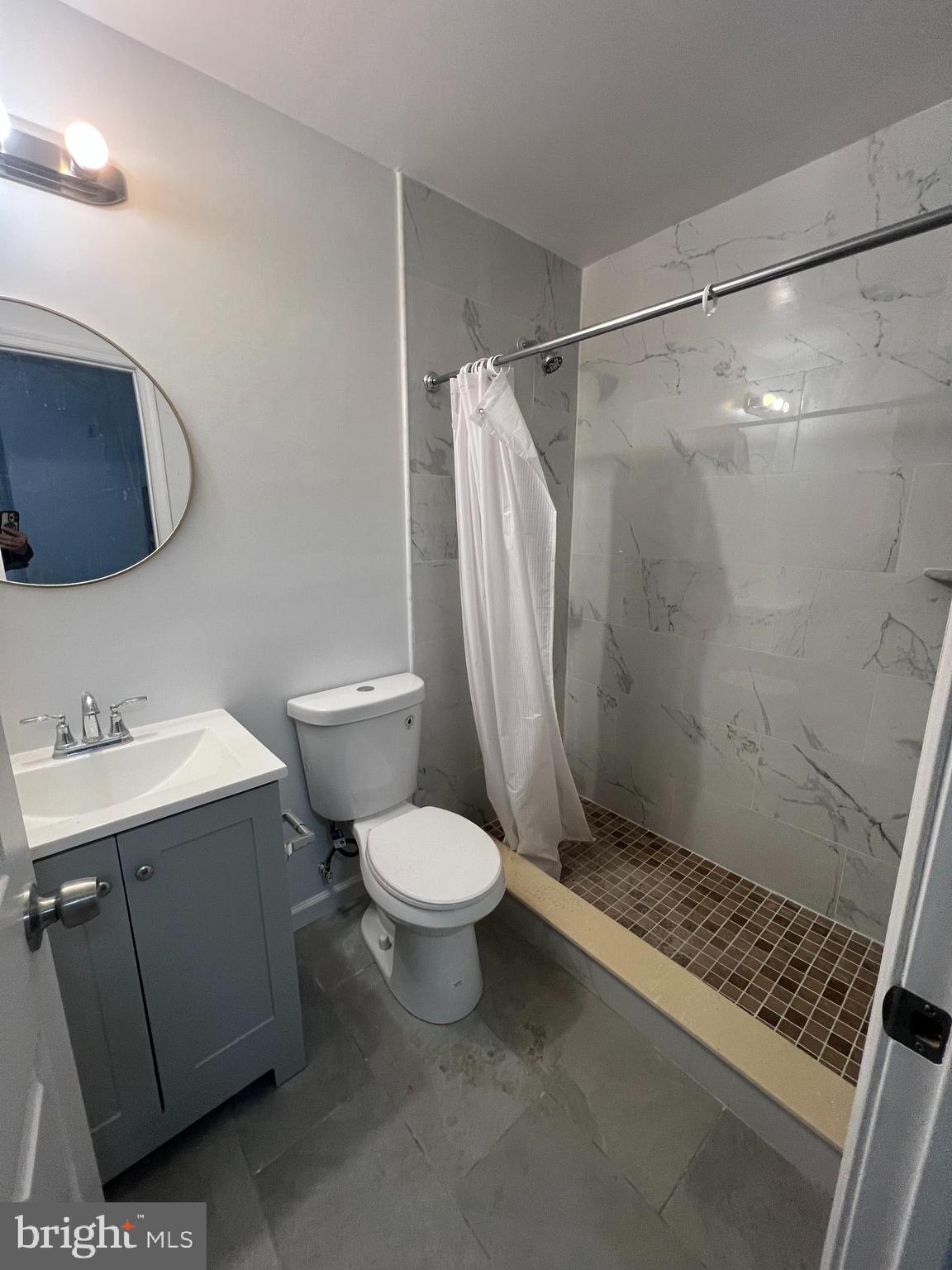 4422 Locust Street, Unit 1 2 Philadelphia, PA 19104 - Photo 6 of 30 a bathroom with a sink toilet and shower