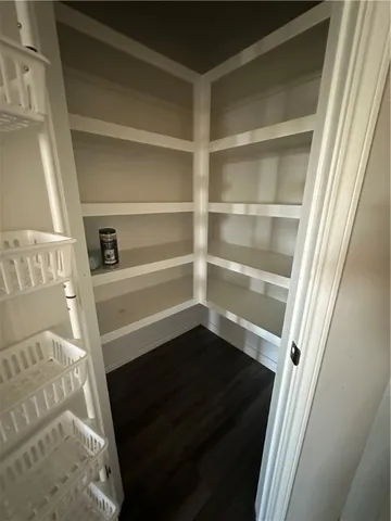 a view of walk in closet with empty racks