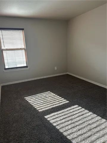 an empty room with wooden floor